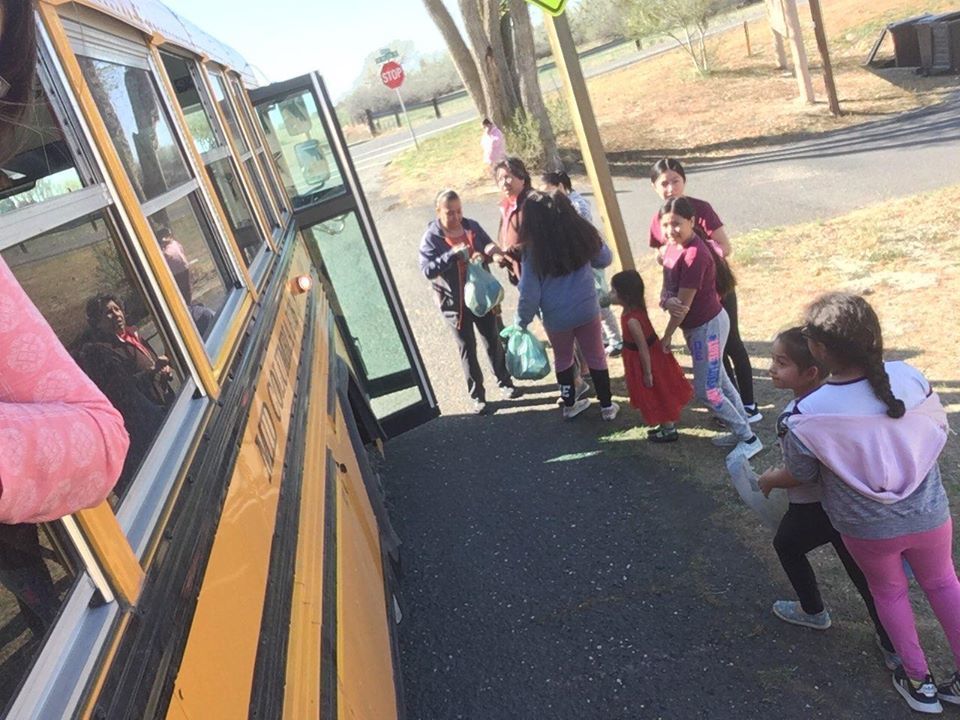 Kids line up at a school bus